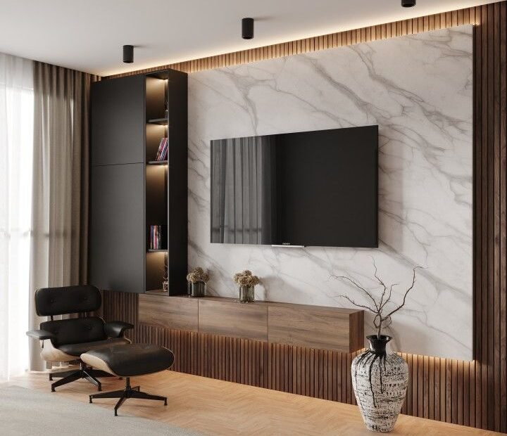 Sala de estar de apartamento moderno com poltrona Eames em frente à TV, parede com detalhes em mármore branco e ripas verticais de madeira